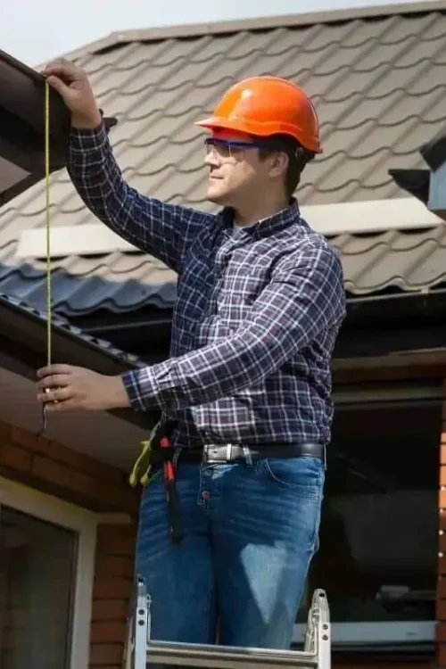 Our professional roof cleaning expert measuring the roof size.